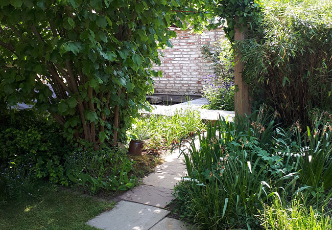 Blick ins Silo. Um einen gemütlichen Garten zu gestalten wurde ein Holzdeck für den Boden gewählt, außerdem gibt es Teiche und Blumenbeete.